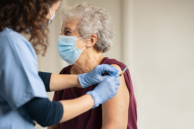 older woman receiving vaccine